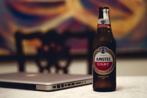 a beer bottle and a laptop