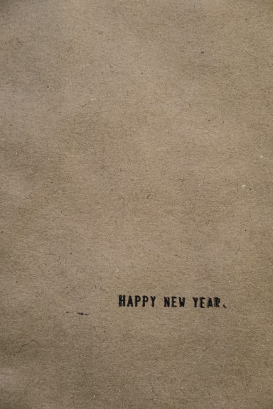 Happy new year printed on brown paper